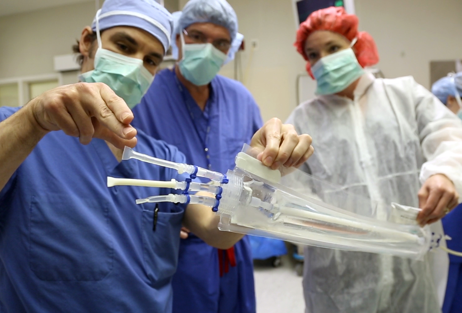 Dr. Heather Prichard instructs Dr. Shawn Gage and Dr. Jeffrey Lawson on opening the packaging