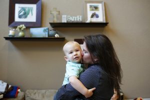 Holly West at home with her son