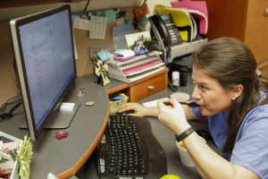 Holly West eating lunch while reading emails