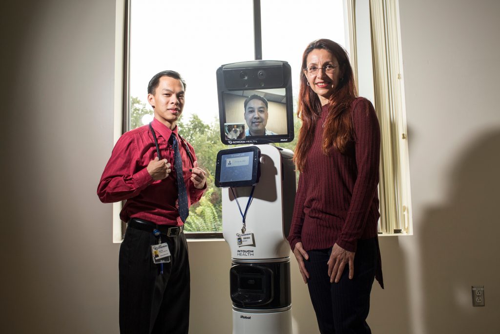 PAs Joey Gee and Nazila Shagagi with Bentley, the telemedicine robot