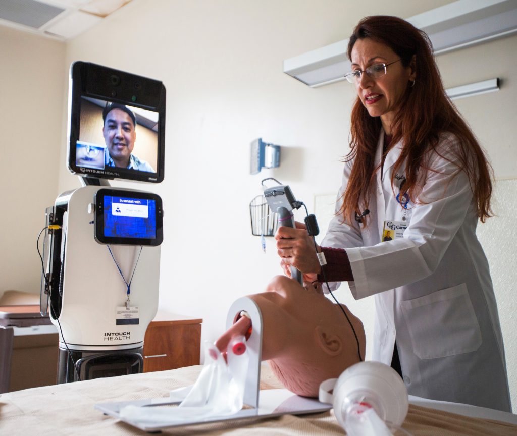 Shagagi demonstrates intubation of a mannequin head as Vo watches via Bentley