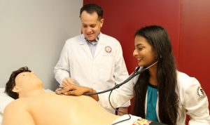 Benjamin J. Smith teaches PA student Holly Daniel bedside cardiac assessment skills