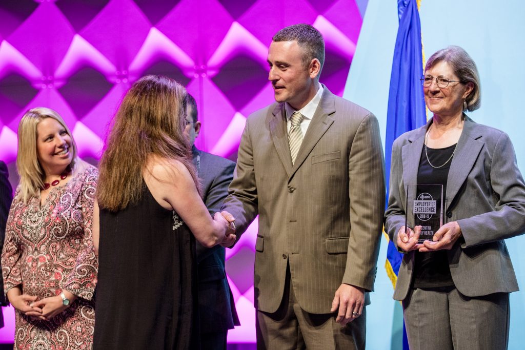 Scott Kastning shaking hands, accepting his EOE award