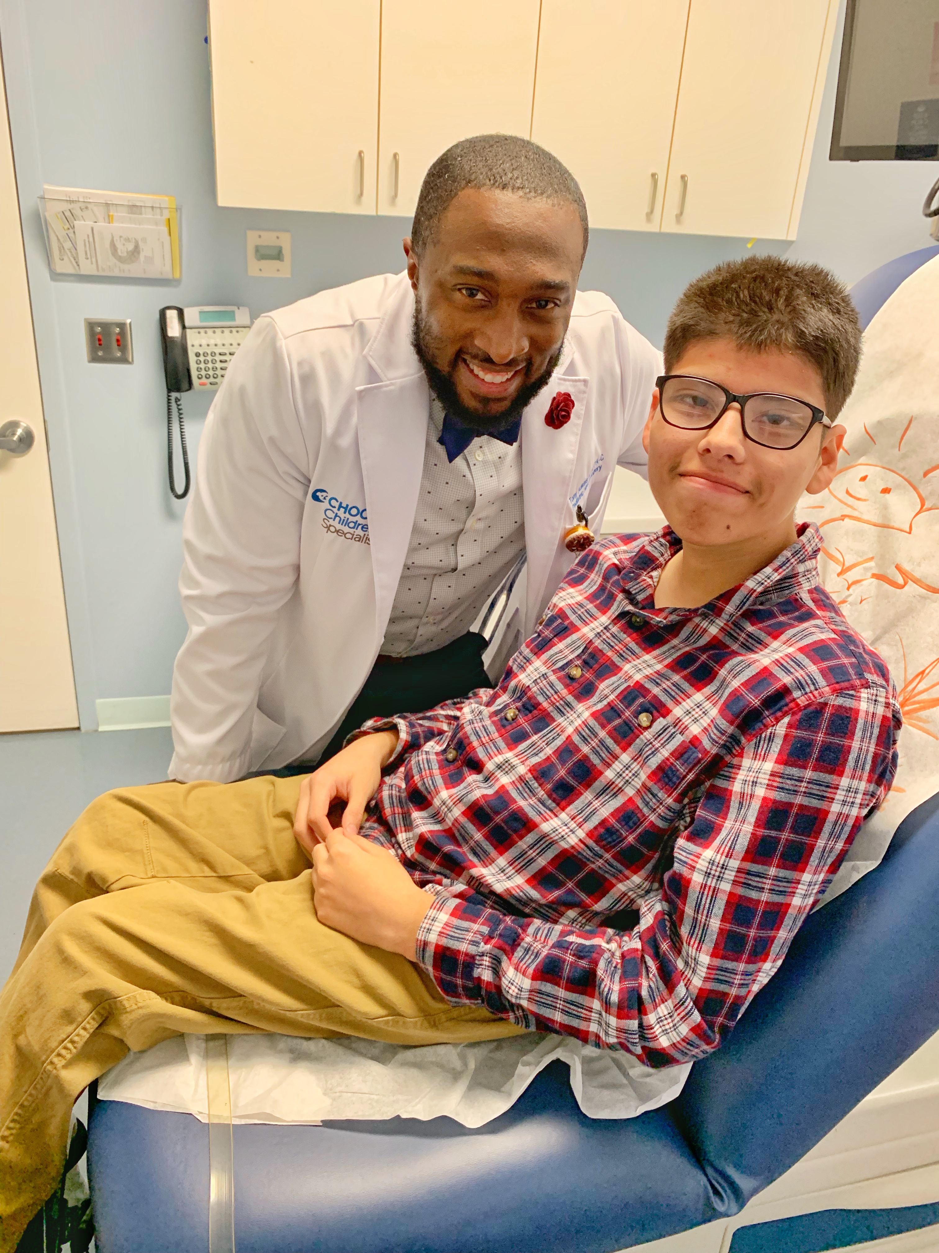 Tony Adkins with a patient in an exam room