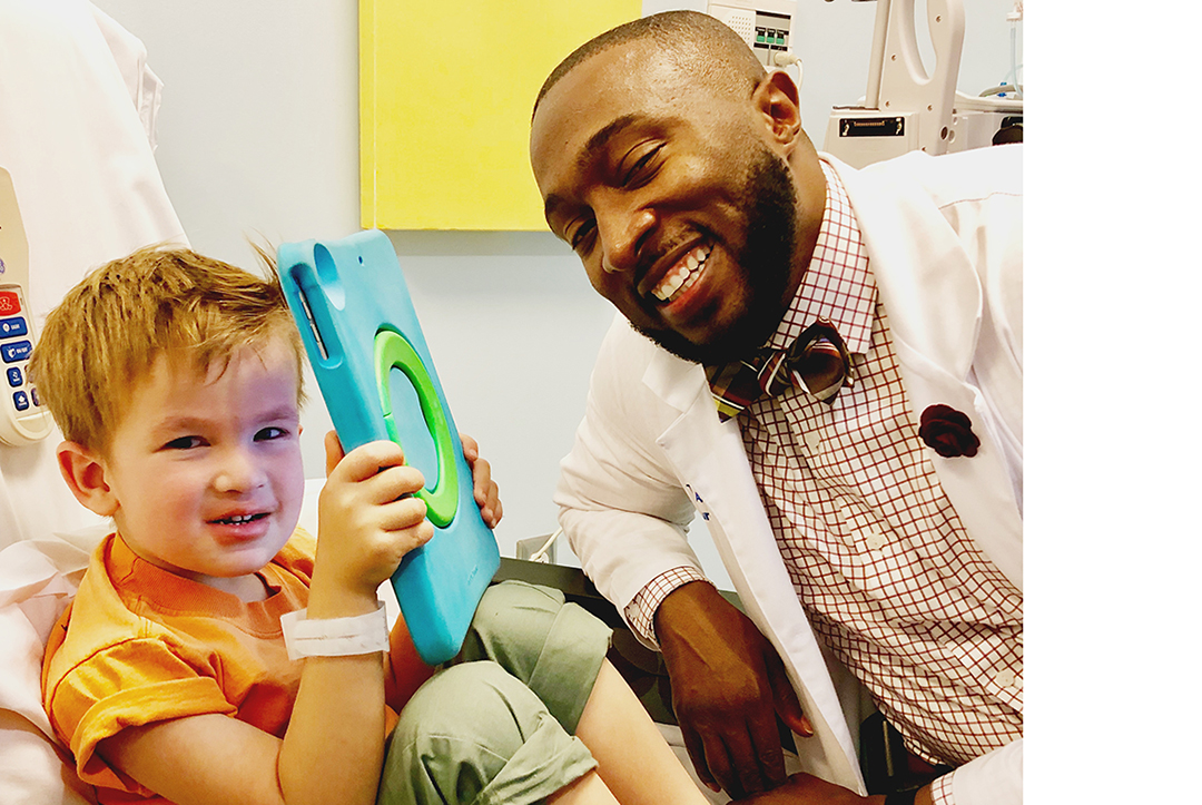 PA Tony Adkins sitting with his patient, Crosby