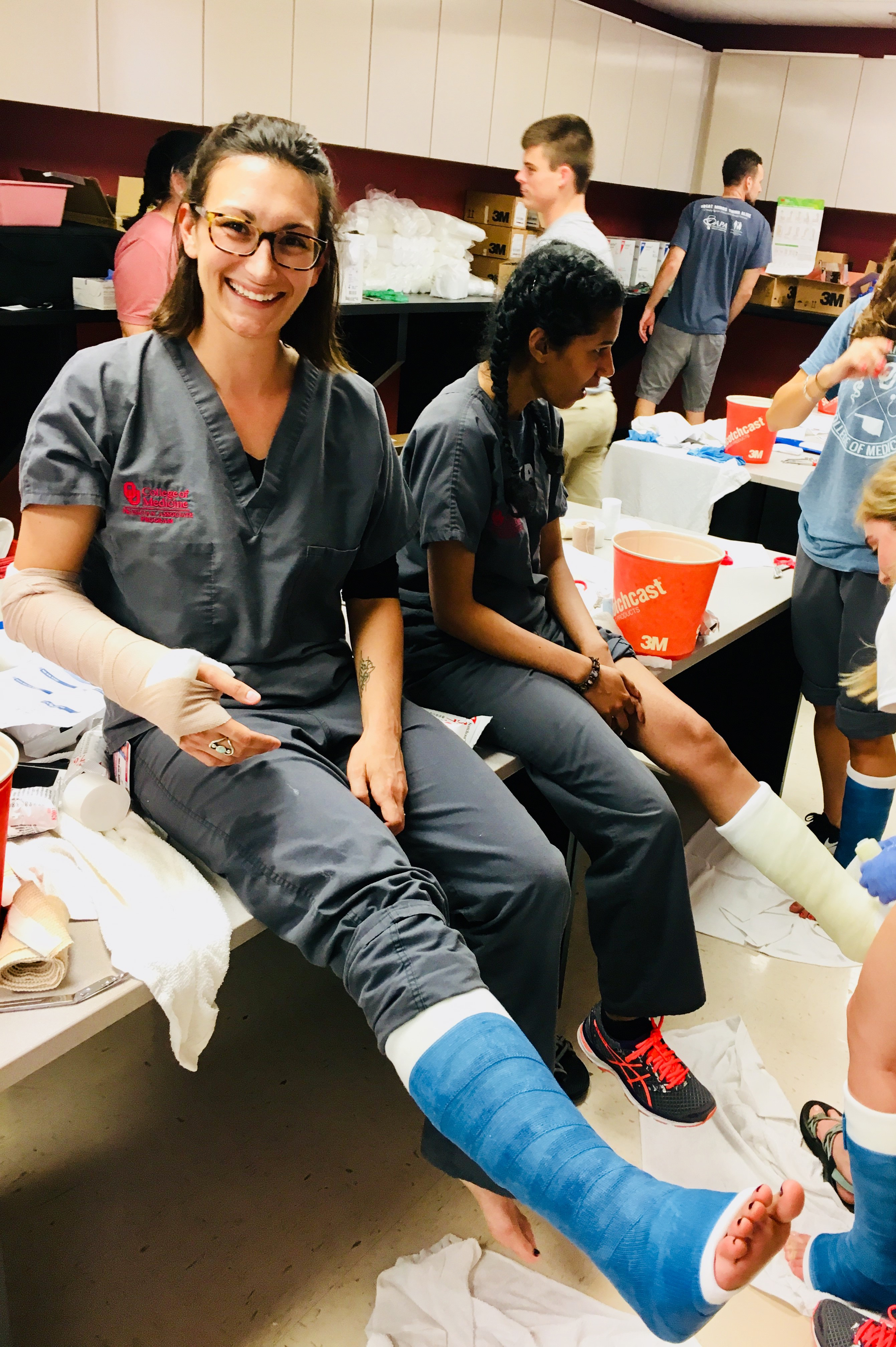 Julie Torres wears casts on her leg and arm