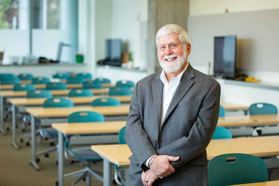 Ted Ruback standing in an empty classroom