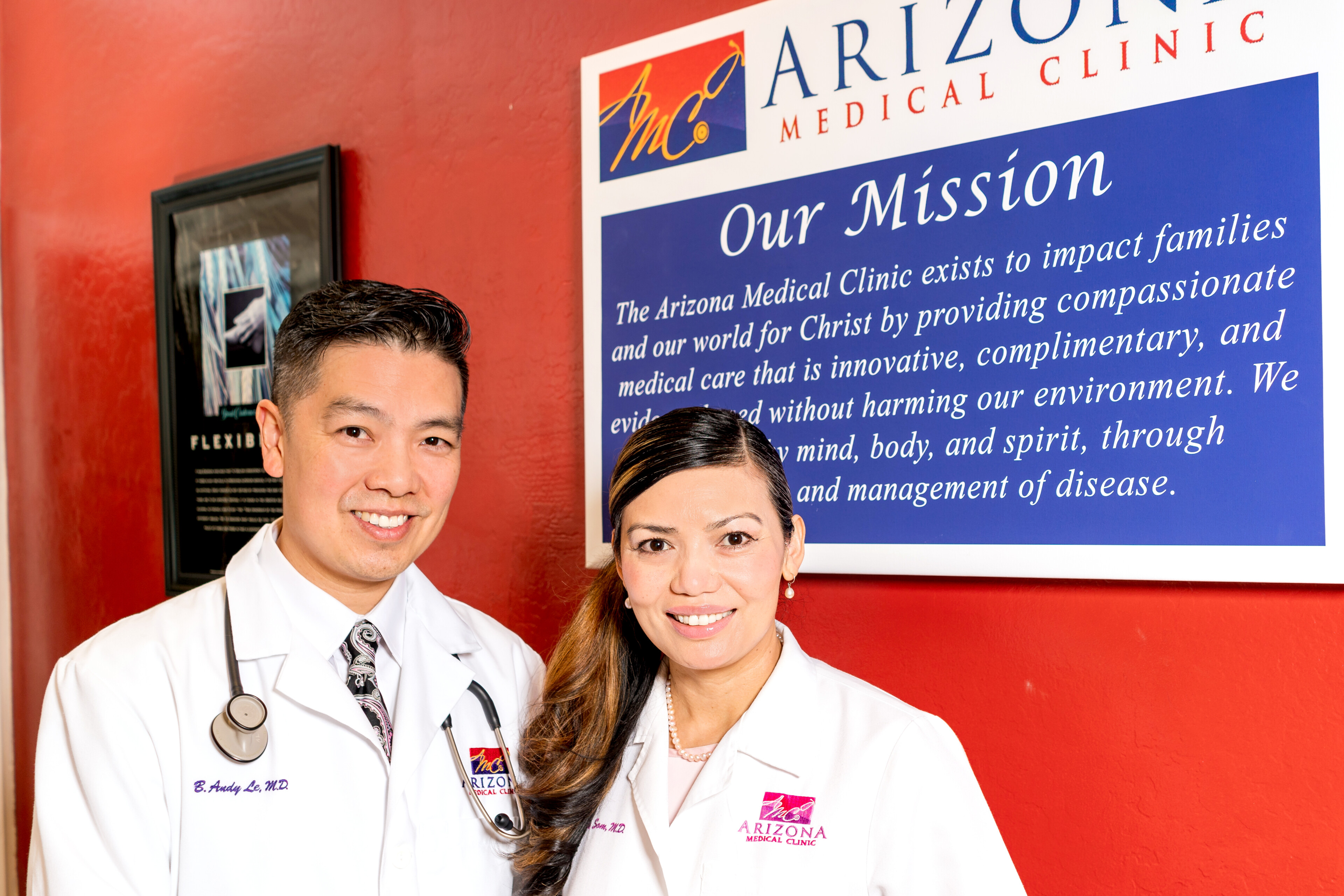 Andy Le and Linda Som next to the Arizona Medical Clinic mission