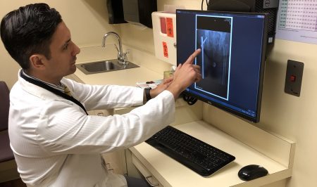 Dan Acevedo pointing at a patient's x-ray