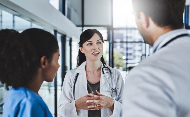 Image of a PA talking to her colleagues.