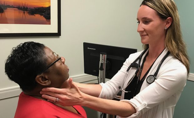 PA checking a patient's neck