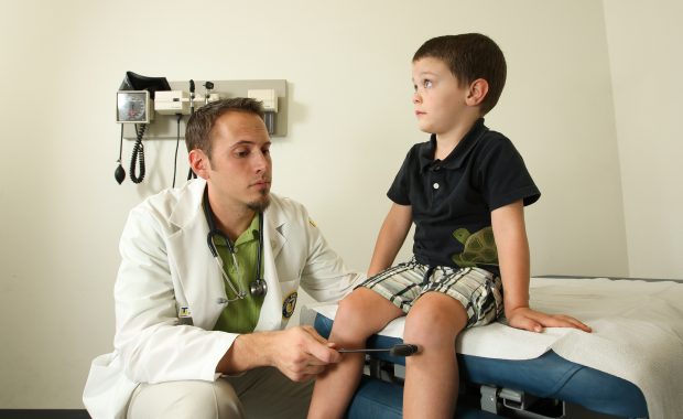 PA working with a young patient