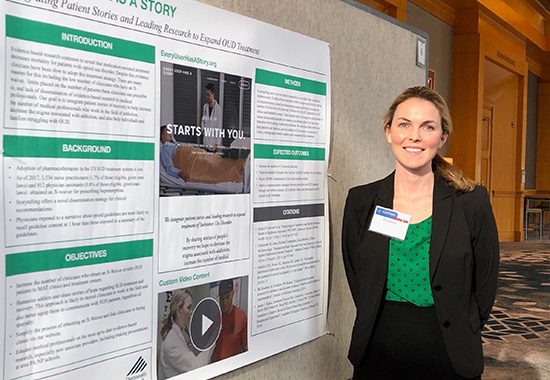 Eleanor Graber standing in front of her project at NIDA's annual conference