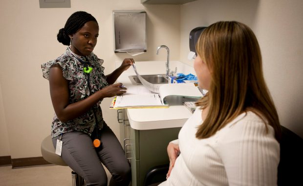 PA listening to her female patient