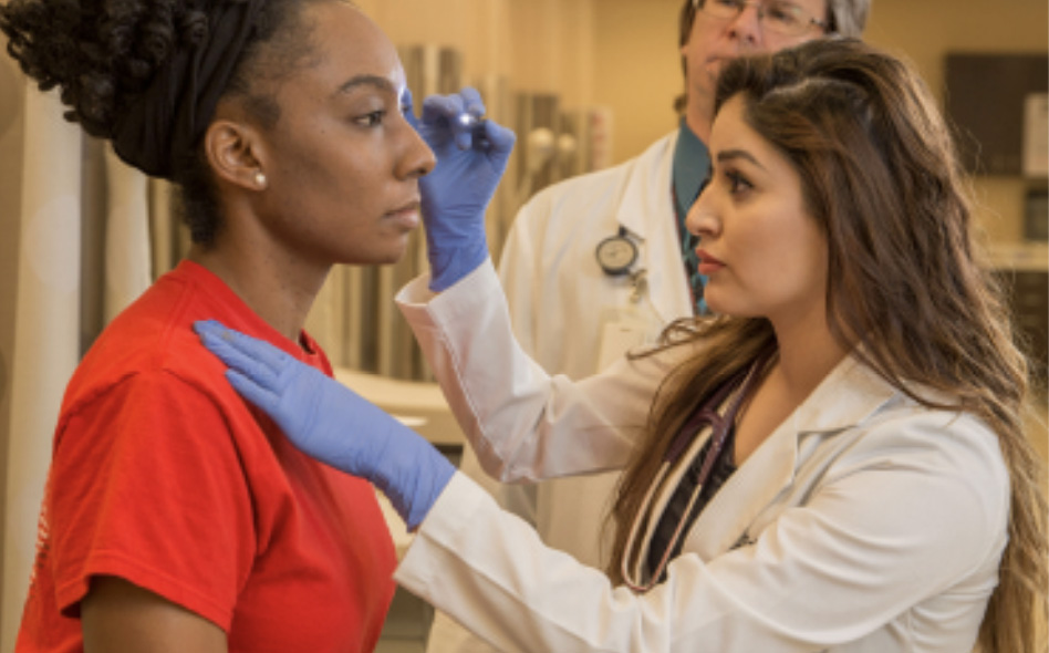 Jiselle Del Cid, PA-C, examining a patient