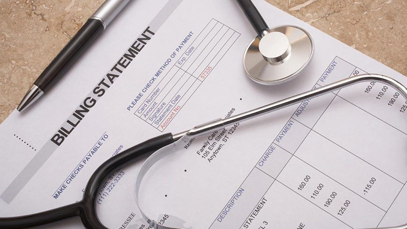 Billing statement paper with a pen and stethoscope on top