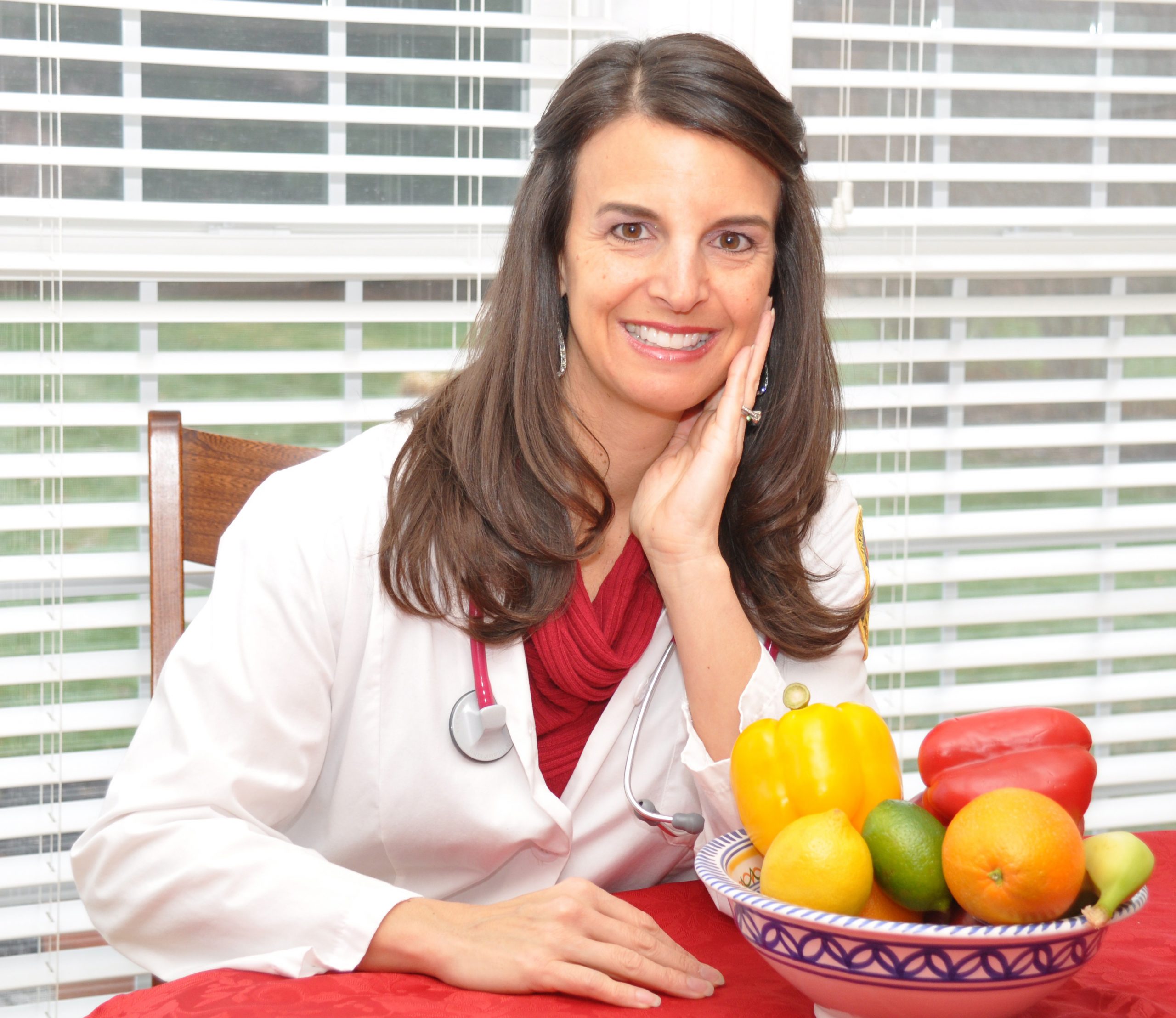 Andrea Atcheson next to a bowl of fruits and vegetables