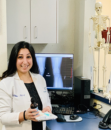 Almas Abbas in front an x-ray