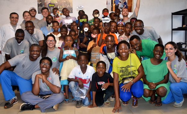 Sixtus Atabong poses with his fellow providers and local children in Cameroon