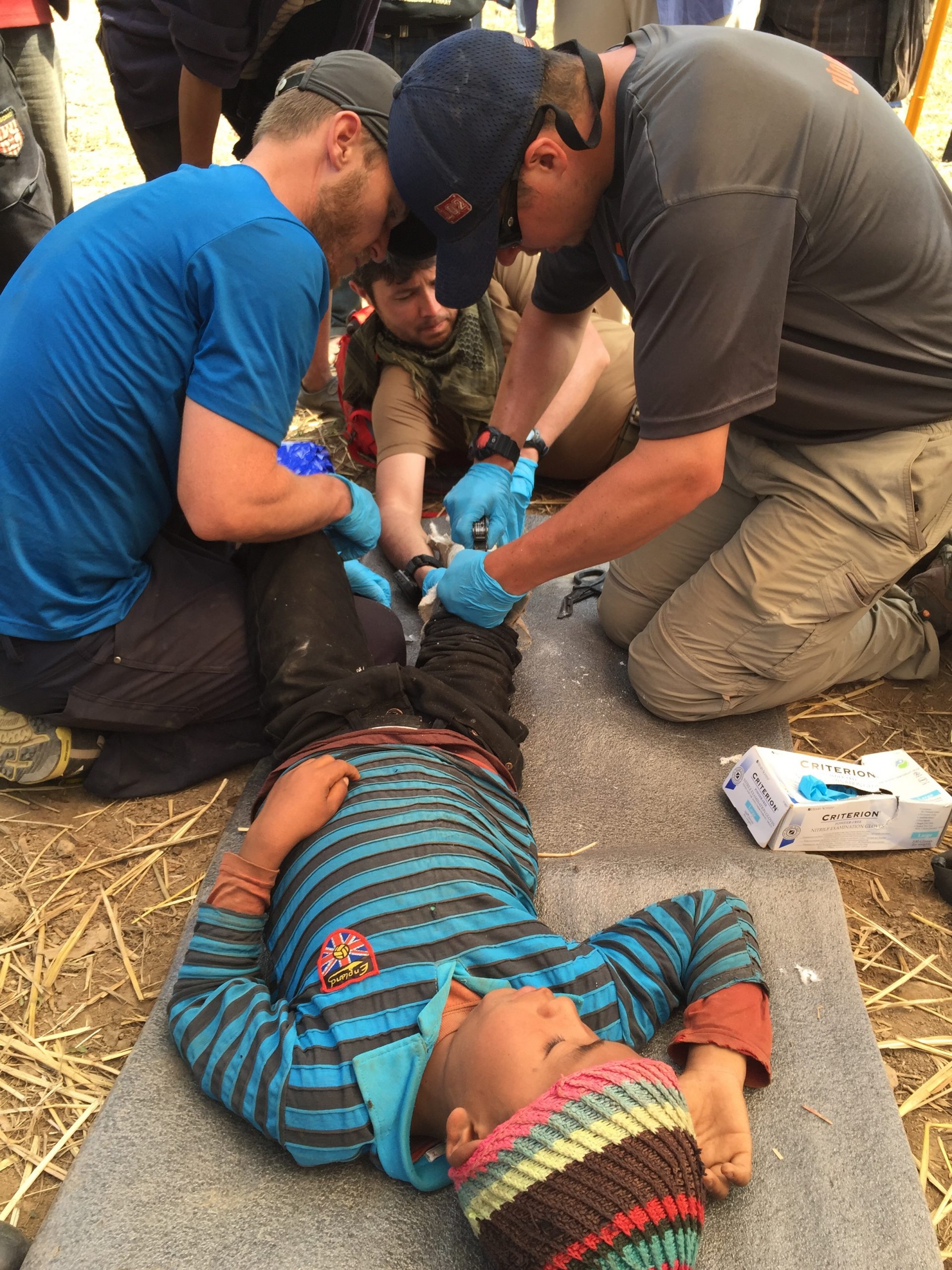 Volunteers address the broken leg of a young child in Nepal