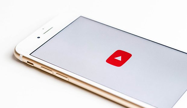 iPhone with YouTube app opening