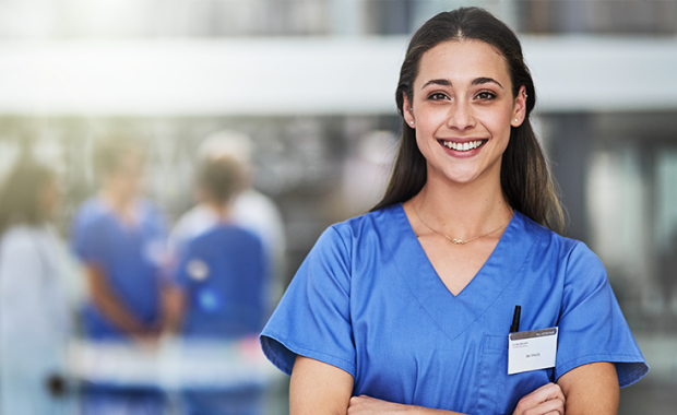 Smiling PA in blue scrubs