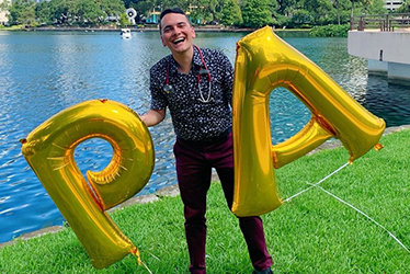 Daniel Mulcahy holding PA balloons