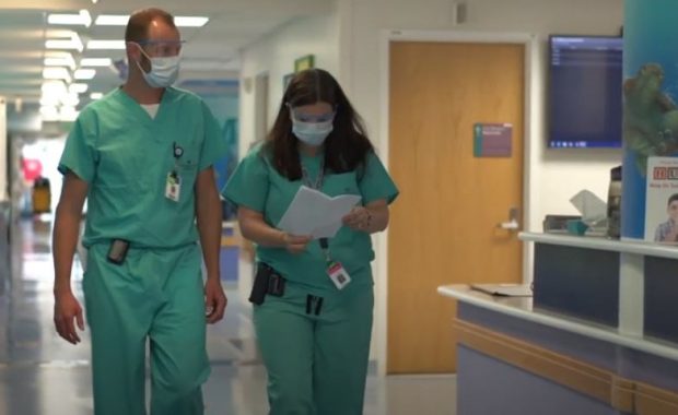 Graham Burdett and Elizabeth Anderson in the hallway