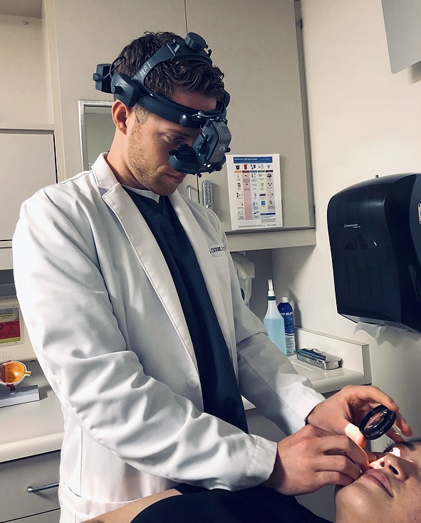 Joel Ciolek examining a patient's eye