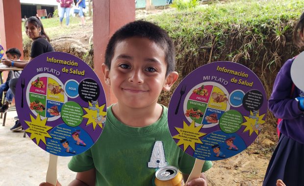 A child poses with medical education resources
