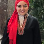 Professional headshot of a young woman in a hijab